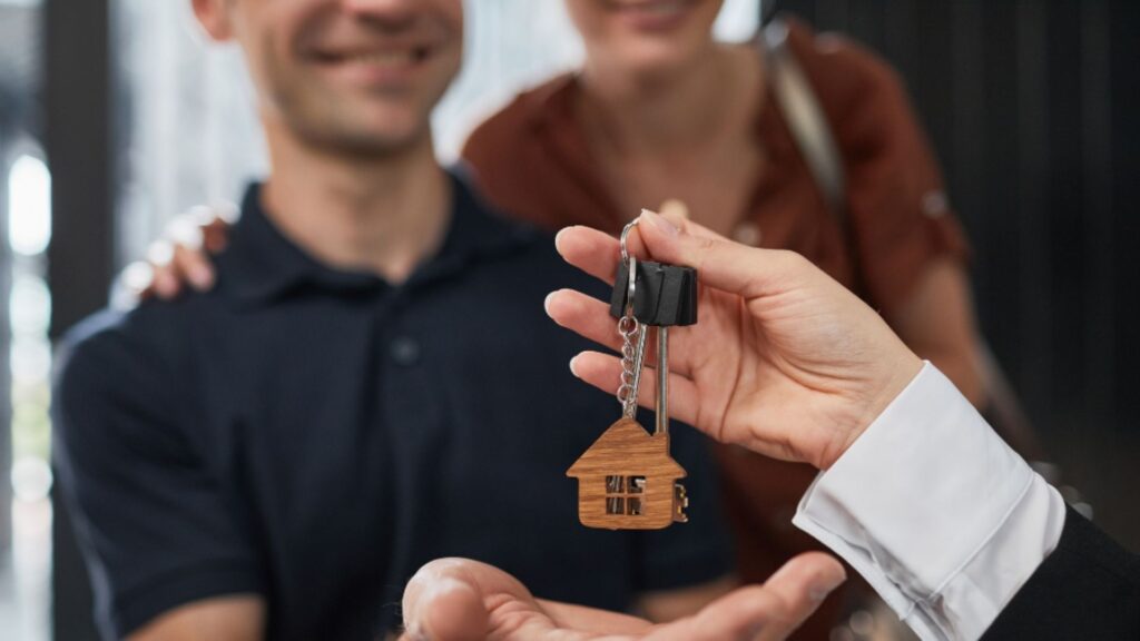 Photo of house keys being handed over to owners
